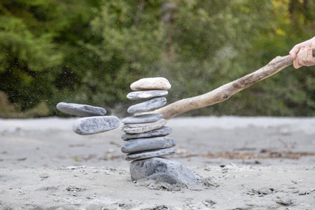 hit a stone tower with a stickの写真素材