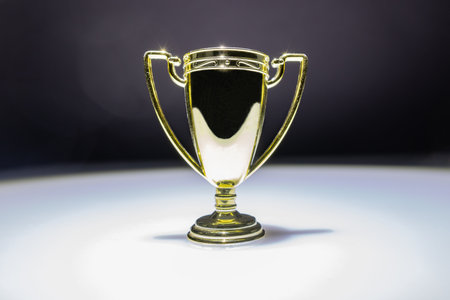 golden cup in white spotlightの写真素材