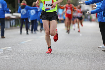 marathon runner passes refreshment stationの写真素材