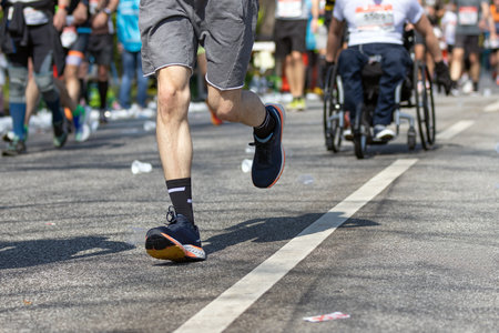 runners and wheelchair user at the hamburg marathonの写真素材