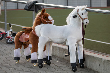 toy horses to sit on on a sports fieldの写真素材