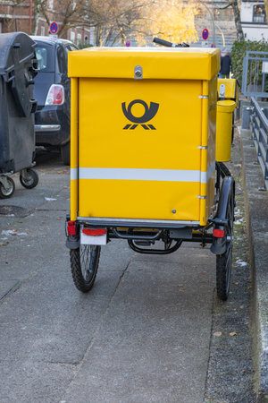 Hamburg, Germany - December, 1, 2023: Postal delivery bike on a sidewalk in Hamburgのeditorial素材