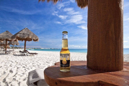 Cancun, Mexico - September 29, 2011: A bottle of Corona (labeled as Coronita in Mexico) under a palapa on Maroma Beach.のeditorial素材