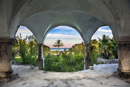 A beautiful view of the ocean from inside an old abandoned mansion.の写真素材