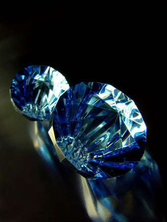 Glass diamonds on black glossy background                        の写真素材