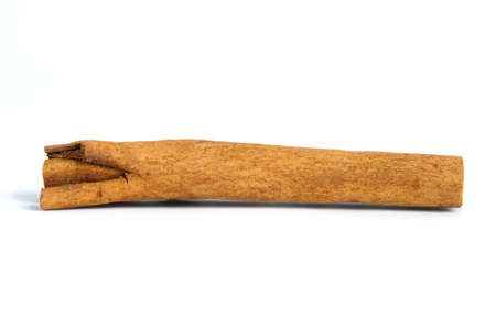 Closeup dried cinnamon stick isolated on a white background with studio lightingの写真素材