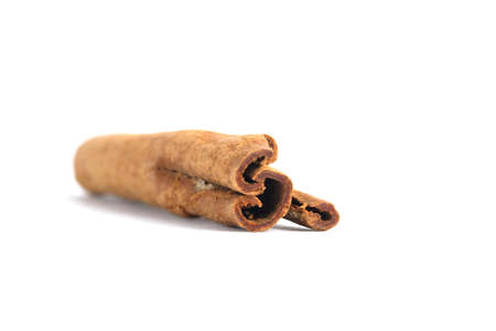 Closeup dried cinnamon stick isolated on a white background with studio lighting