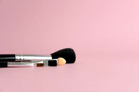 Set of brush makeup tools with pink pastel background. Image photo