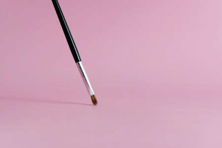 Front view brush makeup tools with pink pastel background. Image photoの写真素材