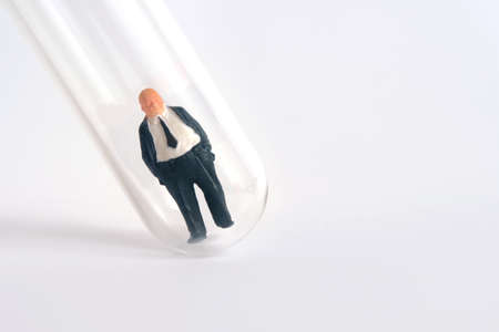 Health conceptual miniature people photography â€“ testing specimen, a businessman on a...