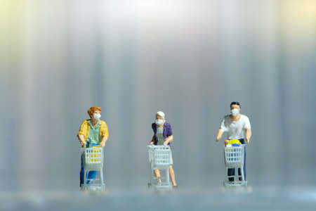 Group of people shopping at supermarket with maintain their physical distance. Miniature people figurines toys conceptual photography.の写真素材