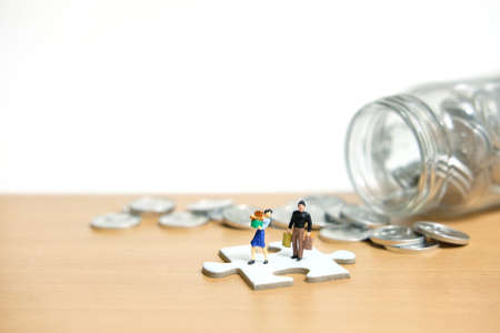 monthly expenditure, women and men standing above white puzzle jigsaw piece spending money....