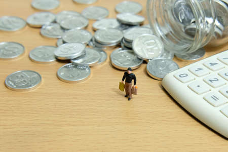 monthly expenditure, men spend money to shop. Miniature people figure conceptual photography.の写真素材