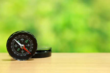 Two black compass standing on wood tableの写真素材