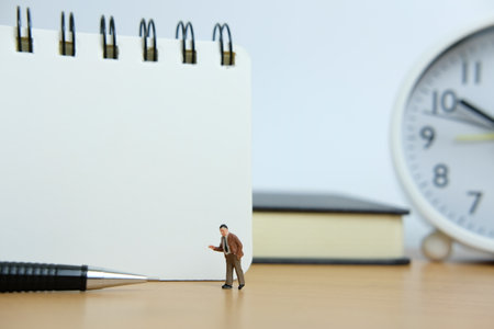 Miniature business concept - writing a resolution list. Mini figure with black white notesの写真素材