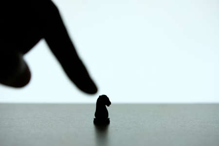 Business strategy conceptual photo - defocused hand pointing horse chessの写真素材