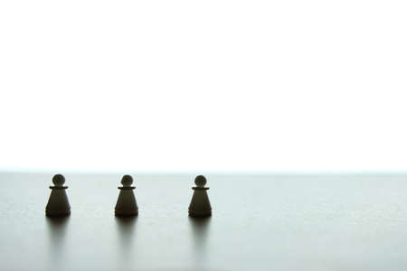Business strategy conceptual photo - Silhouette of three chess pawn on a table