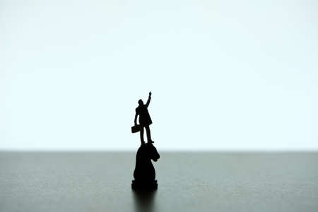 Business strategy conceptual photo - Silhouette of miniature businessman pointing upside, standing...