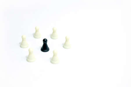 Miniature business strategy concept - black pawn standing between chess piece - top viewの写真素材
