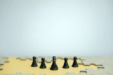 Conceptual photo of business strategy - a line of horse chess pieces in the middle of an army and...