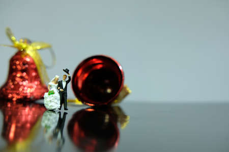 Miniature wedding concept. Bride and groom walking out make greeting after wedding procession. image photoの写真素材