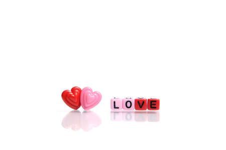Red and pink heart shape with LOVE word beads. Romance conceptの写真素材
