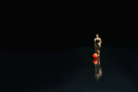 Miniature photography - elegant women singer singing on shiny black stage with reflectionの写真素材