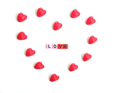 Red and pink heart beads shape, top view flat lay with white background. Love and romance conceptual...