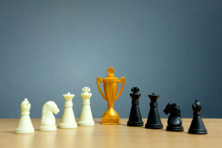 Golden trophy in the middle of chess pawnの写真素材