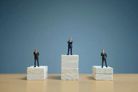 Business strategy conceptual photo - Miniature of businessman stands on a podiumの写真素材