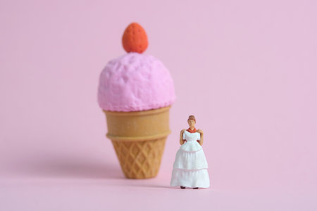 Woman dieting from ice cream and fat before wedding day concept. Miniature people toys photography,...