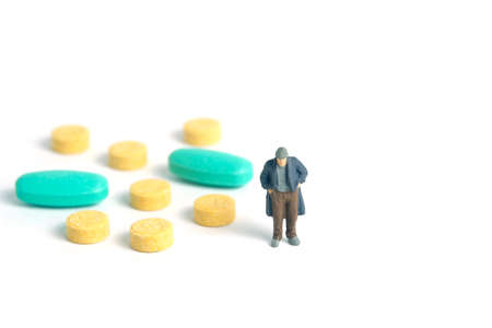 The poor man with no money can't pay the medical bills, drug pill receipt. Miniature tiny people...