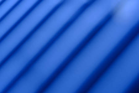 Abstract macro photography. Soft blurred metal texture, line pattern background with blue lightの写真素材