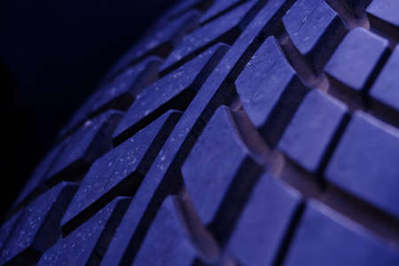 Abstract macro photography. Close up tire texture pattern with purple lightの写真素材