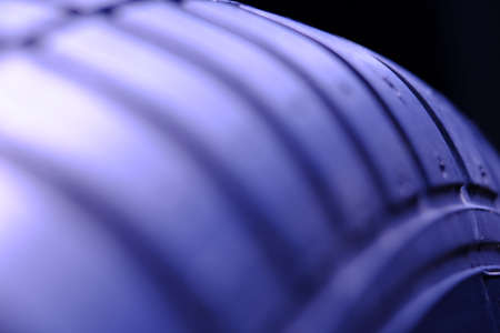 Abstract macro photography. Close up tire texture pattern with purple lightの写真素材