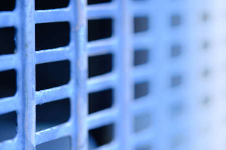 Abstract macro photography. Close up blue fence with square grid patternの写真素材
