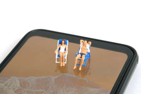 Miniature people toy figure photography. Virtual travel concept, Men and girl relaxing seat at chair...