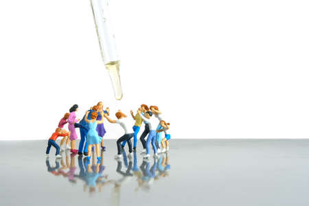 Miniature people toy figure photography. Group of people jostling for vaccine. Image photoの写真素材