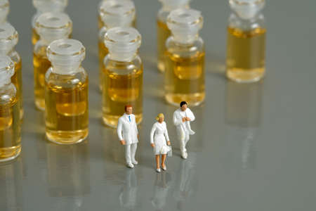 Miniature people toy figure photography. Vaccination distribution concept. A group of doctor walking...