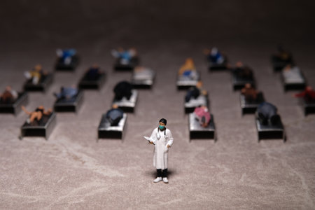 Miniature people toy figure photography. Full bed hospital occupancy rate concept. A doctor standing in front of patient. Image photoの写真素材