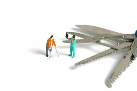 Miniature people toy figure photography. A men broken bones with doctor looking on X-ray results...