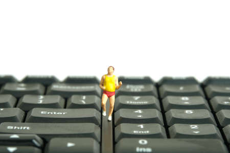 Miniature people toy figure photography. Escape from working daily routine concept. A fat men runner jogging above black keyboard, isolated on white background. Image photoの写真素材