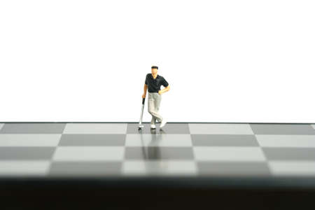 Miniature people toy figure photography. Winning tournament concept. A men golfer standing above...