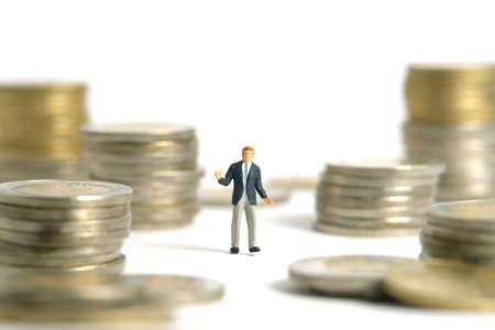 Miniature people toy figure photography. Financial plan concept. A shrugging businessman stand above...