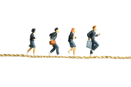 Miniature people toy figure photography. School problem for students in rural areas concept. Pupils running above rope bridge tunnel isolated on white background. Image photoの写真素材