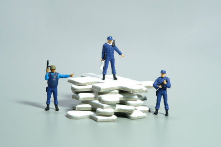 Miniature people toy figure photography. Protection strategy concept. A security officer standing...
