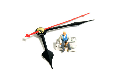 Miniature people toy figure photography. Hourly rate professional worker. Men worker sitting above...
