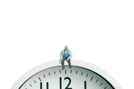 Miniature people toy figure photography. A men worker take a break rest sitting and waiting above...