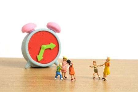 Miniature people toy figure photography. Playing time concept. Kids play together in front of rubber...