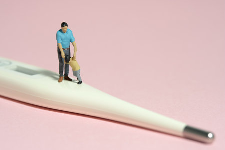 Miniature people toy figure photography. Refusing body temperature check concept. A father and son...